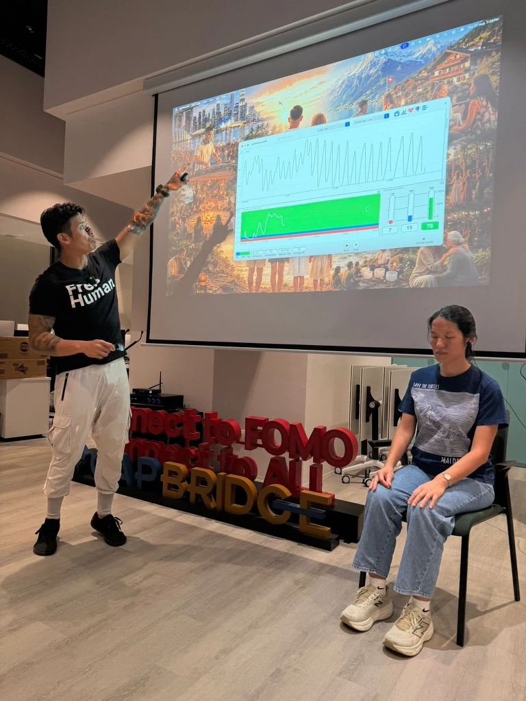 Luke demonstrating breathwork with a participant during a session for Stanford Business School alumni