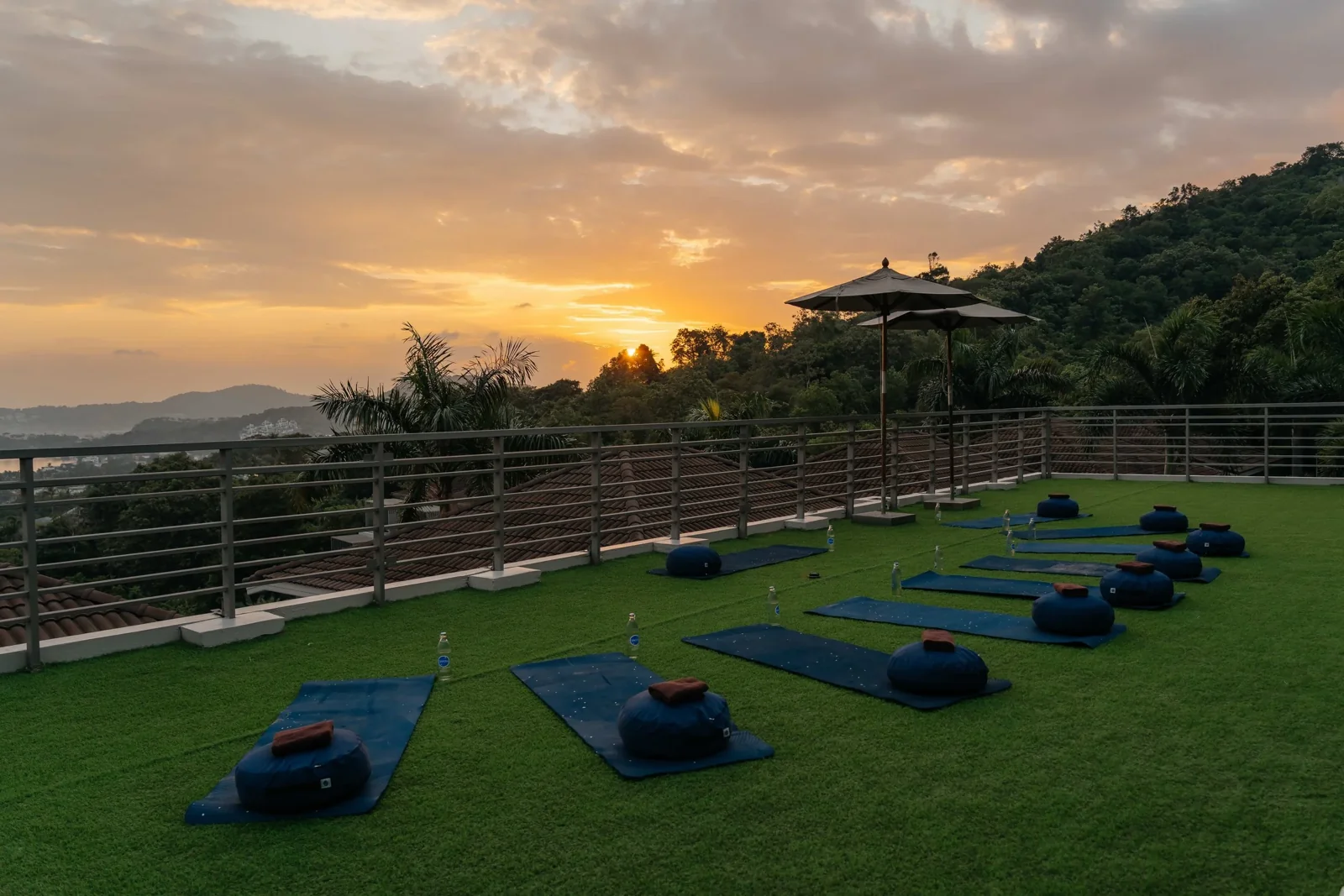 Mats and headphones prepared on the SAOL terrace at Mantra Samui at sunset