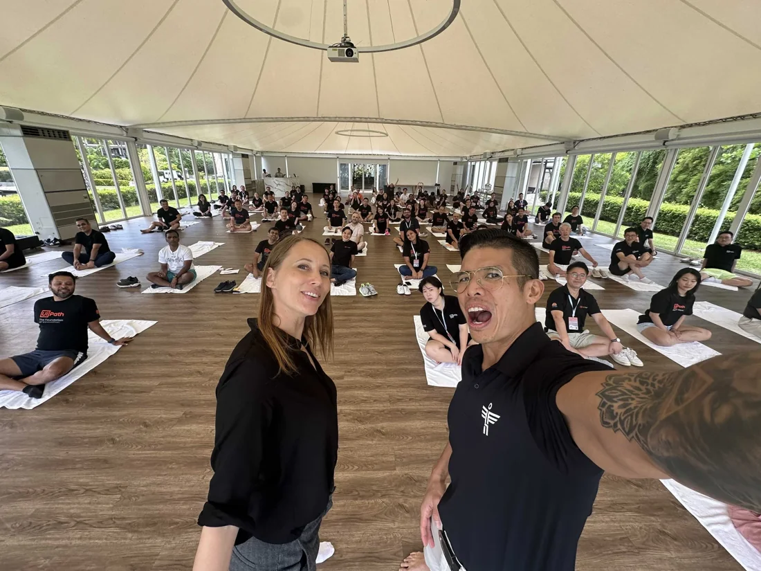 Luke and Candice with the UiPath group in a circular pavilion